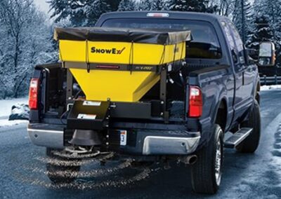 Commercial Street De-Icing. Spraying salt on the roadway.