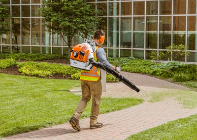 Blowing off sidewalk