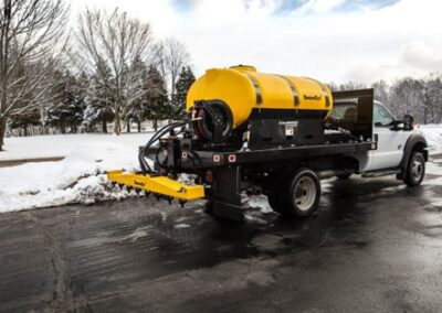 De-Icing Truck using a Brine Solution on a road.